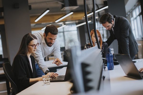 Group of young business people are working together with desktop