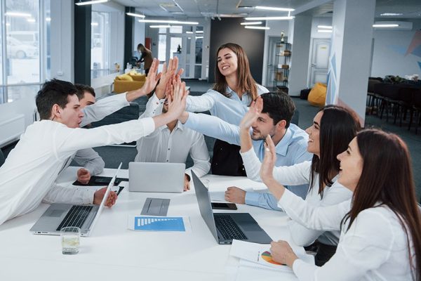 Cheerful business people. Job is done. Group of office workers happy to hit their own records and being successful.