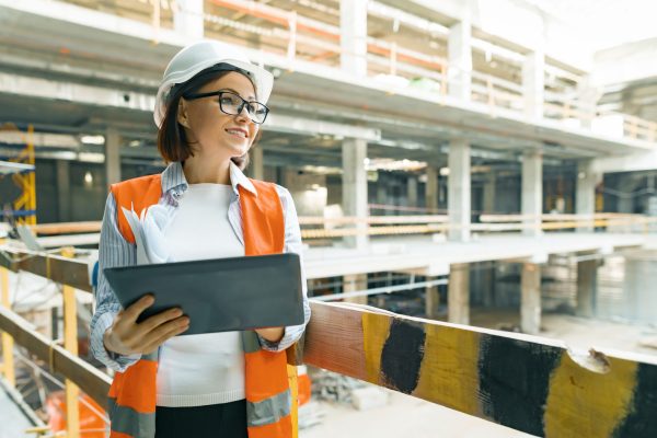 Portrait of mature architect woman at a construction site. Building, development, teamwork and people concept.